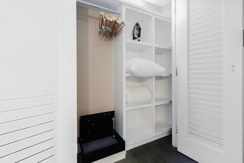 Large closets with hangers, extra linens, and iron. 